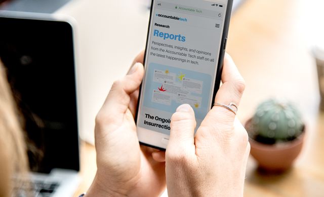 woman-holding-iphone-browsing-accountable-tech-website